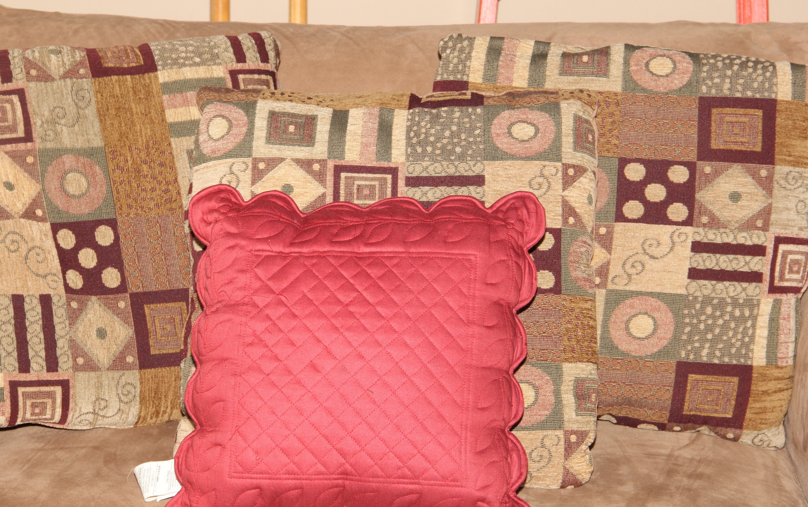 Beige Loveseat and Decorative Throw Pillows