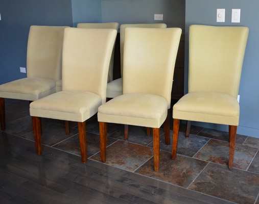 Oval Granite Top Dining Table and Six Beige Chairs