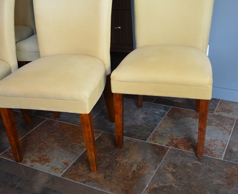 Oval Granite Top Dining Table and Six Beige Chairs