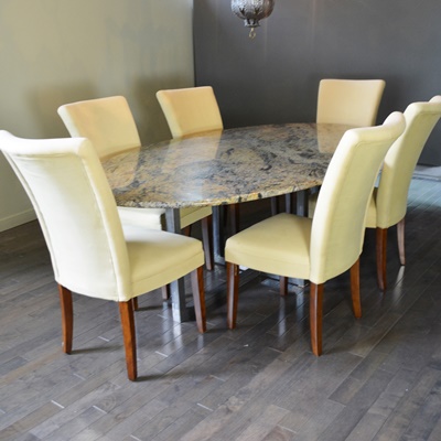 Oval Granite Top Dining Table and Six Beige Chairs