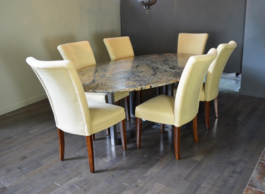 Oval Granite Top Dining Table and Six Beige Chairs