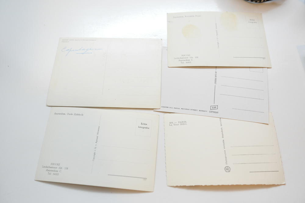 Vintage Travel Items Including Postcards of India and Disney Camera Strap