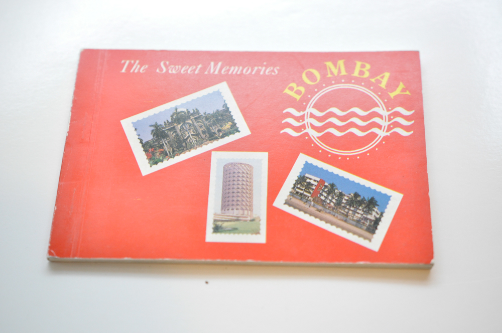 Vintage Travel Items Including Postcards of India and Disney Camera Strap