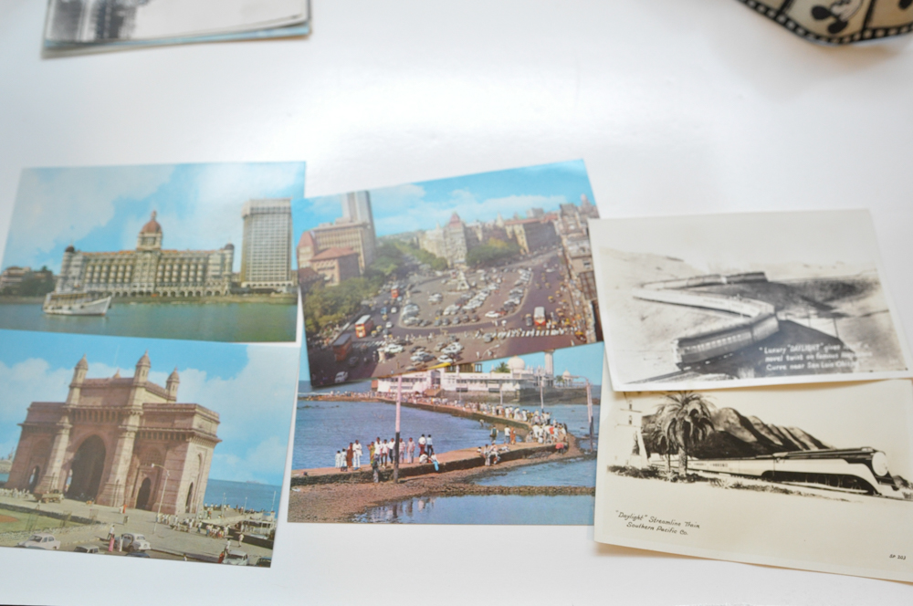 Vintage Travel Items Including Postcards of India and Disney Camera Strap