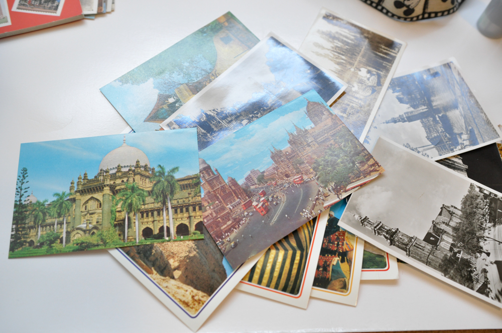 Vintage Travel Items Including Postcards of India and Disney Camera Strap