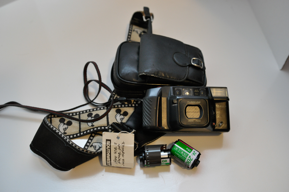 Vintage Travel Items Including Postcards of India and Disney Camera Strap