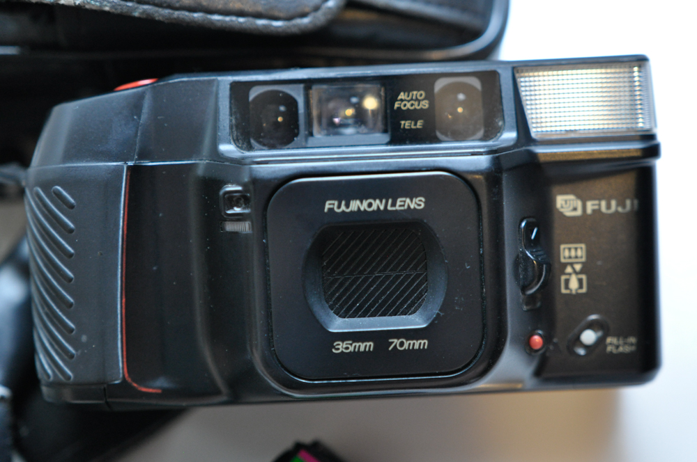 Vintage Travel Items Including Postcards of India and Disney Camera Strap