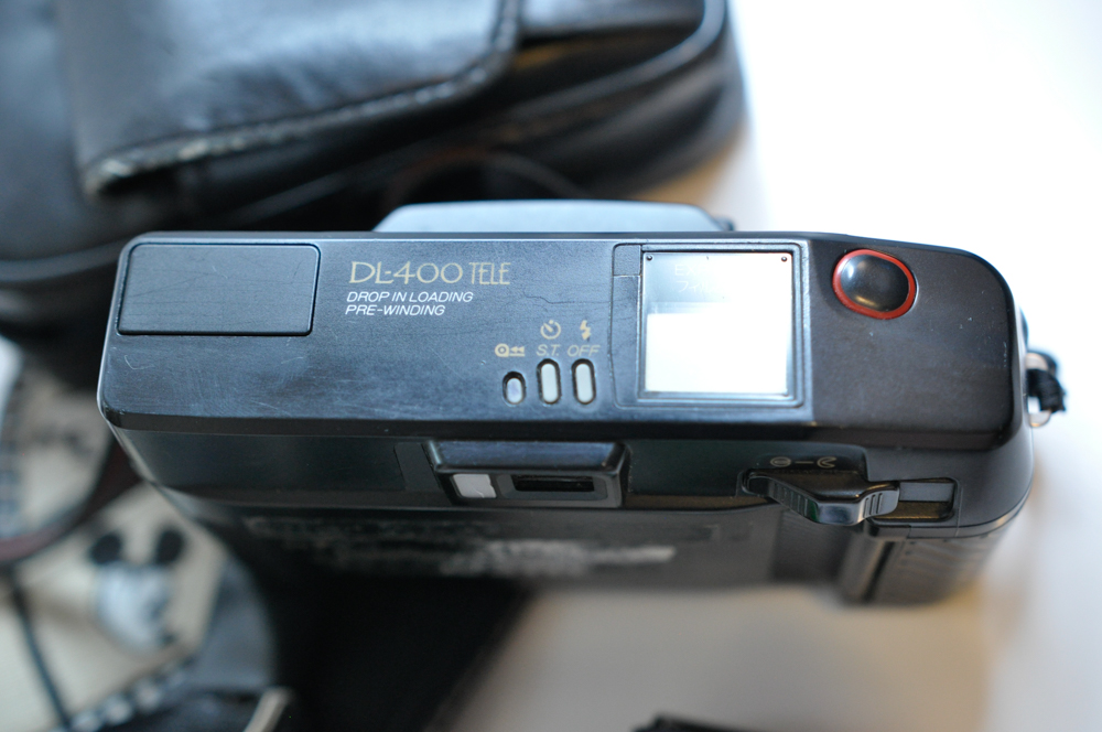 Vintage Travel Items Including Postcards of India and Disney Camera Strap