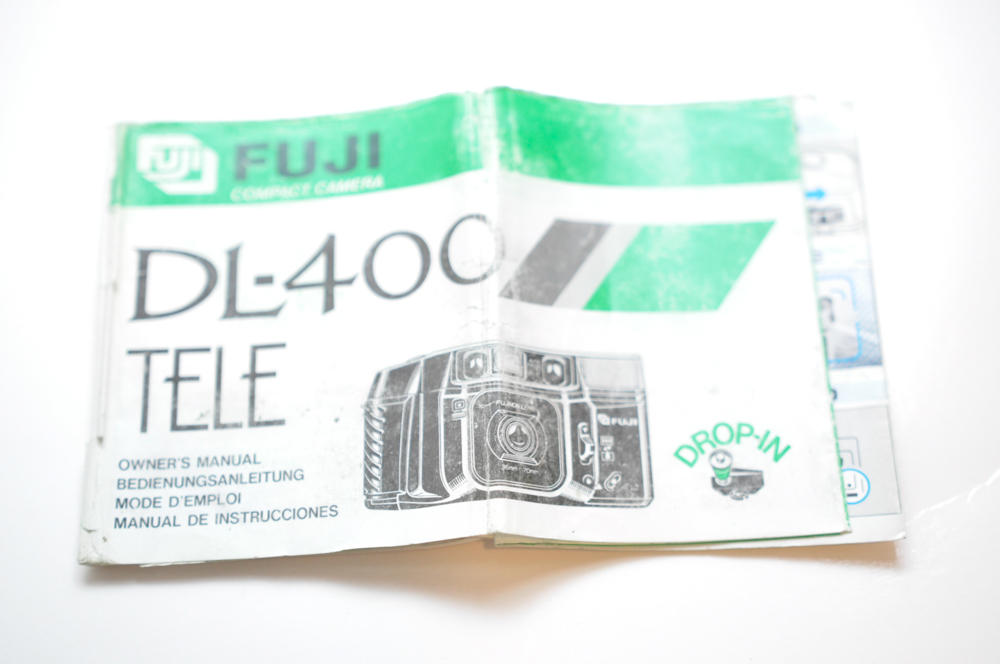 Vintage Travel Items Including Postcards of India and Disney Camera Strap