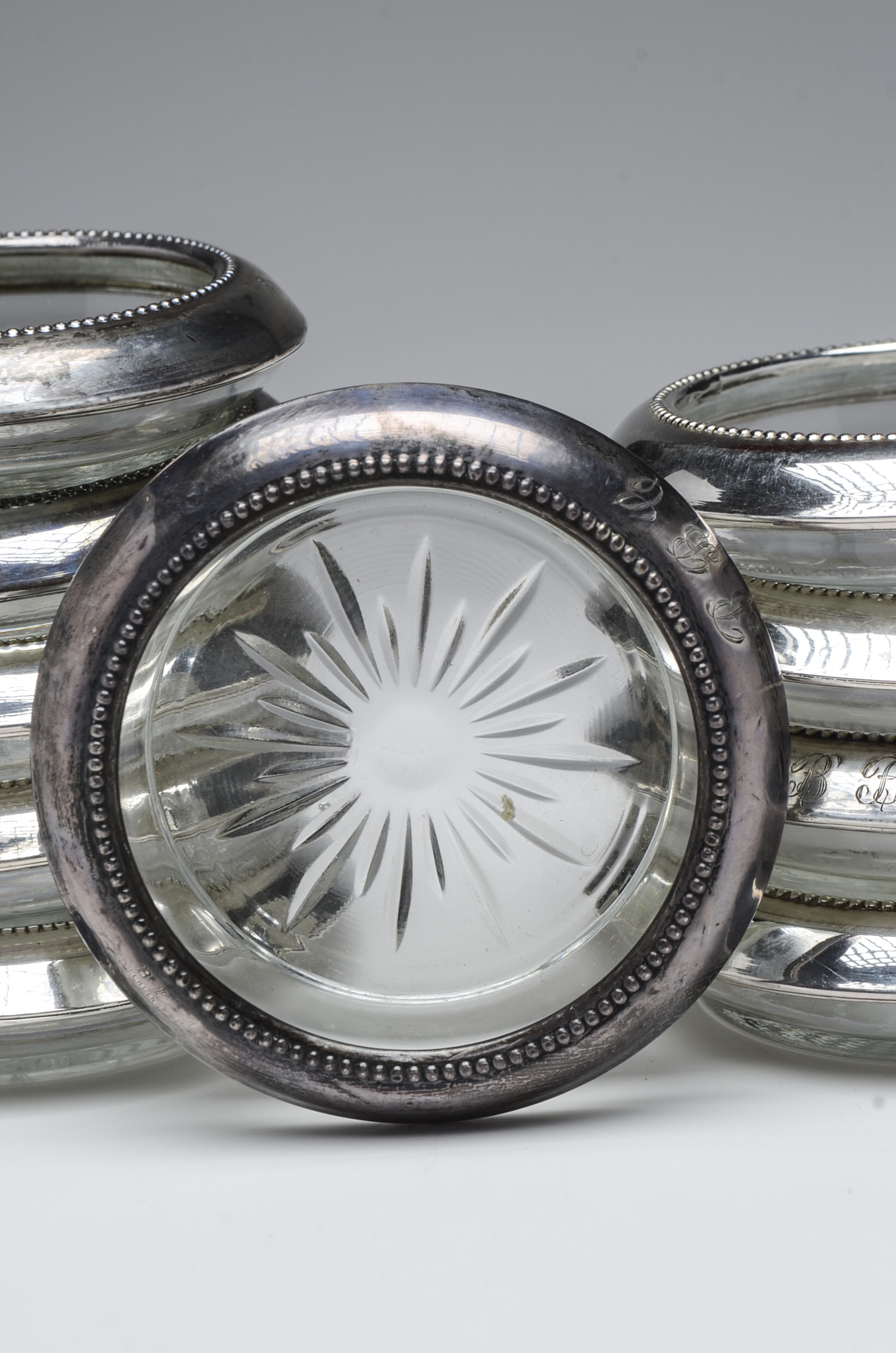Ten Pressed Glass Coasters with Sterling Silver Rim