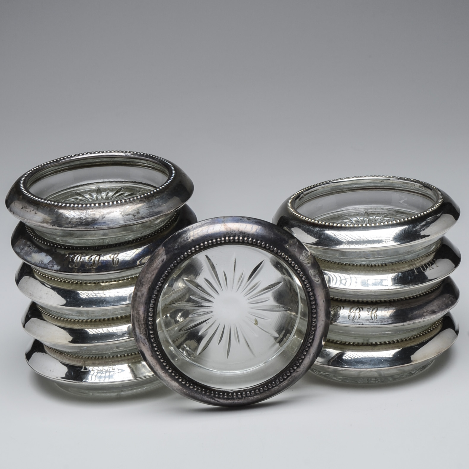 Ten Pressed Glass Coasters with Sterling Silver Rim