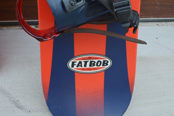 K2 Fat Bob Snow Board and Two Plastic Sleds