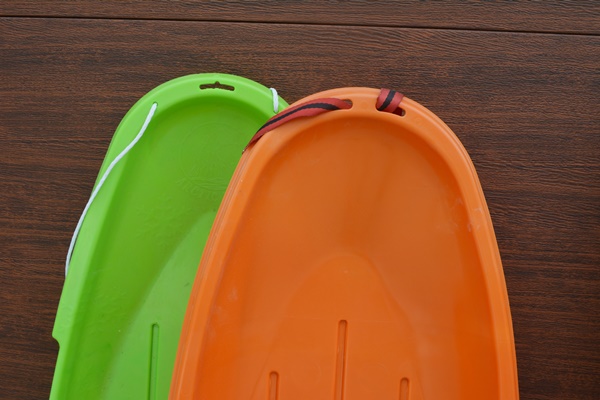 K2 Fat Bob Snow Board and Two Plastic Sleds