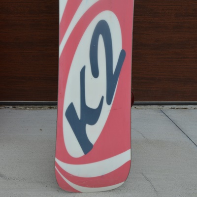 K2 Fat Bob Snow Board and Two Plastic Sleds