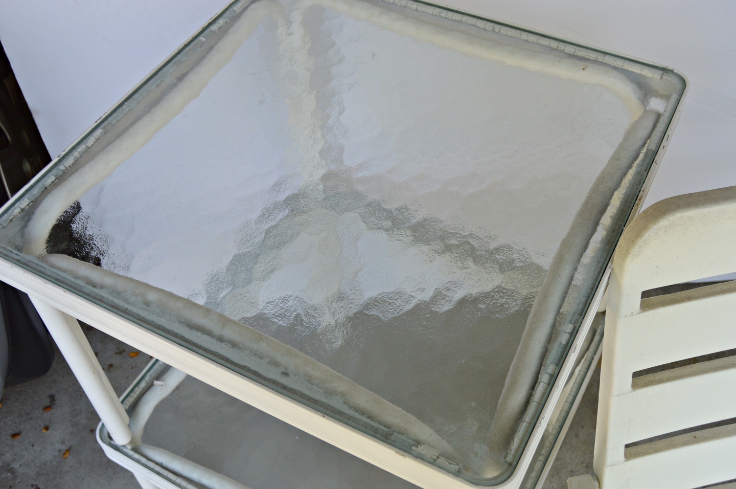 Pair of White Metal and Glass Top Patio Tables and Folding Chair