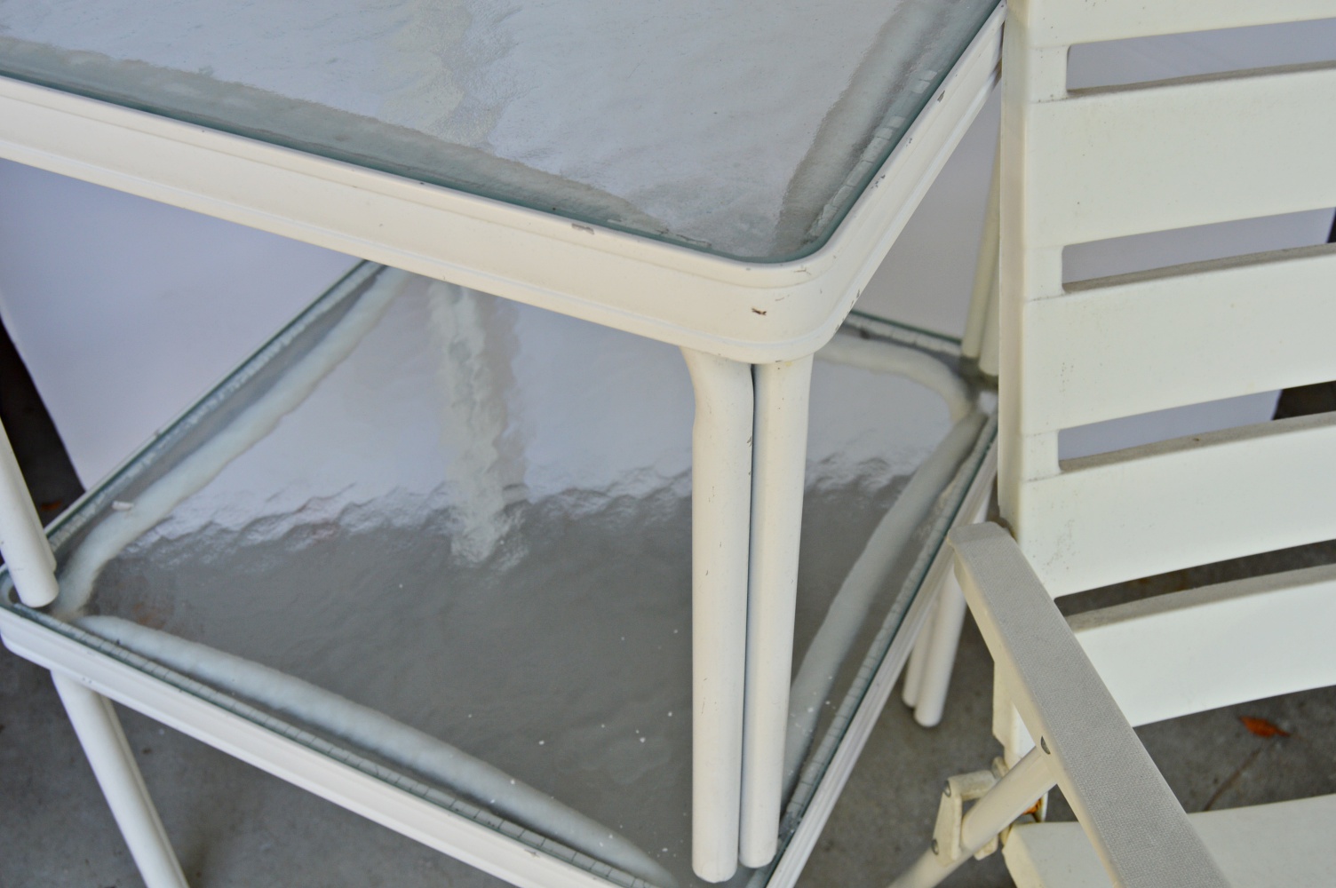 Pair of White Metal and Glass Top Patio Tables and Folding Chair