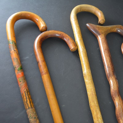 Four Wood Walking Sticks and One Aluminum Walking Stick