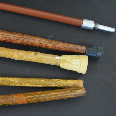 Four Wood Walking Sticks and One Aluminum Walking Stick