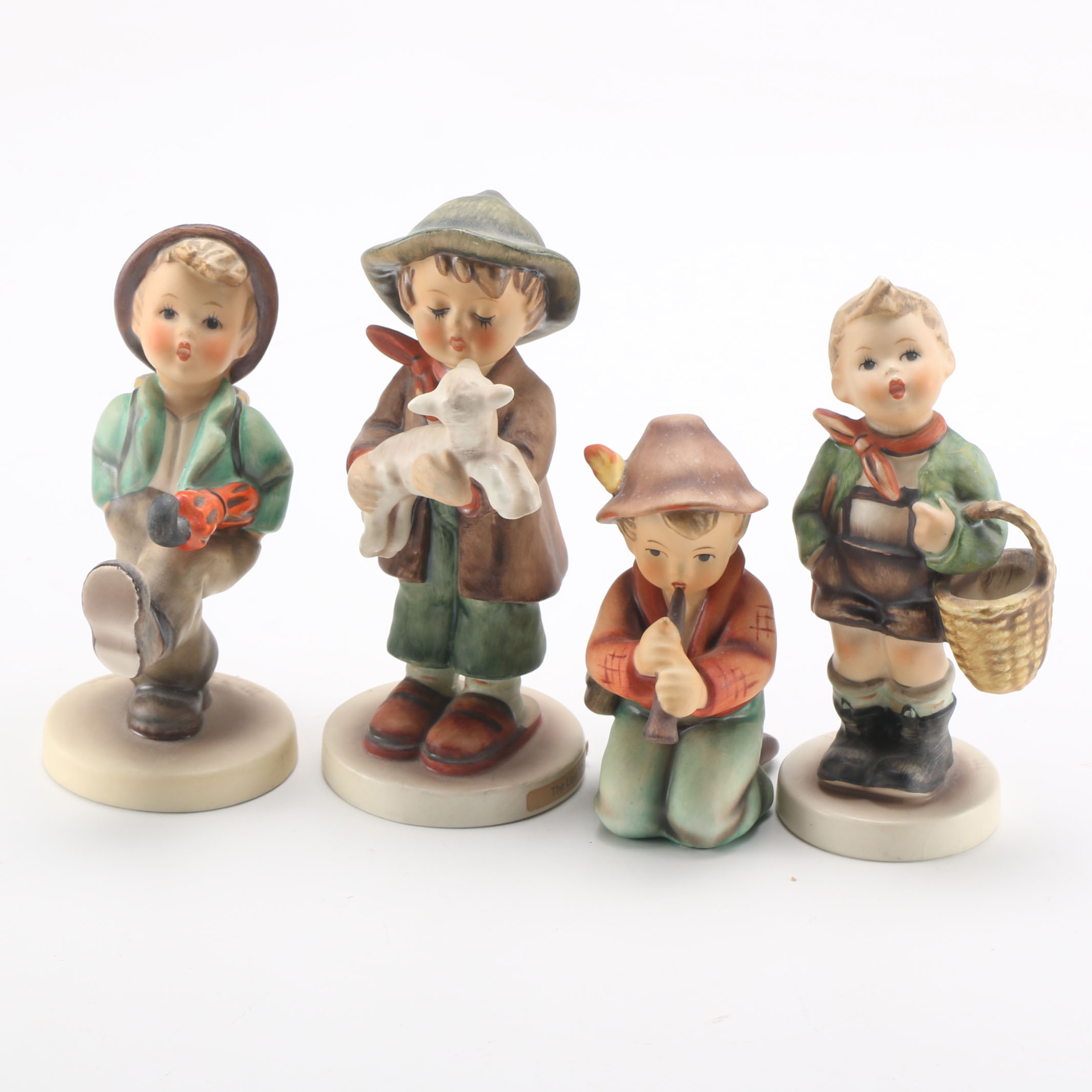 Goebel Hummels "Little Tooter", "Village Boy", "Globe Trotter", and "Lost Sheep"