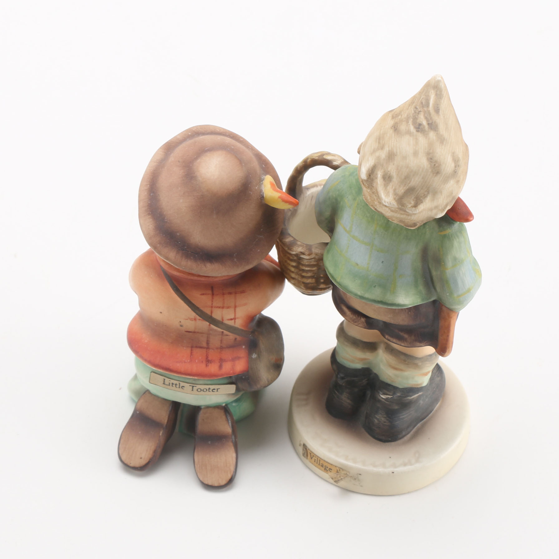 Goebel Hummels "Little Tooter", "Village Boy", "Globe Trotter", and "Lost Sheep"