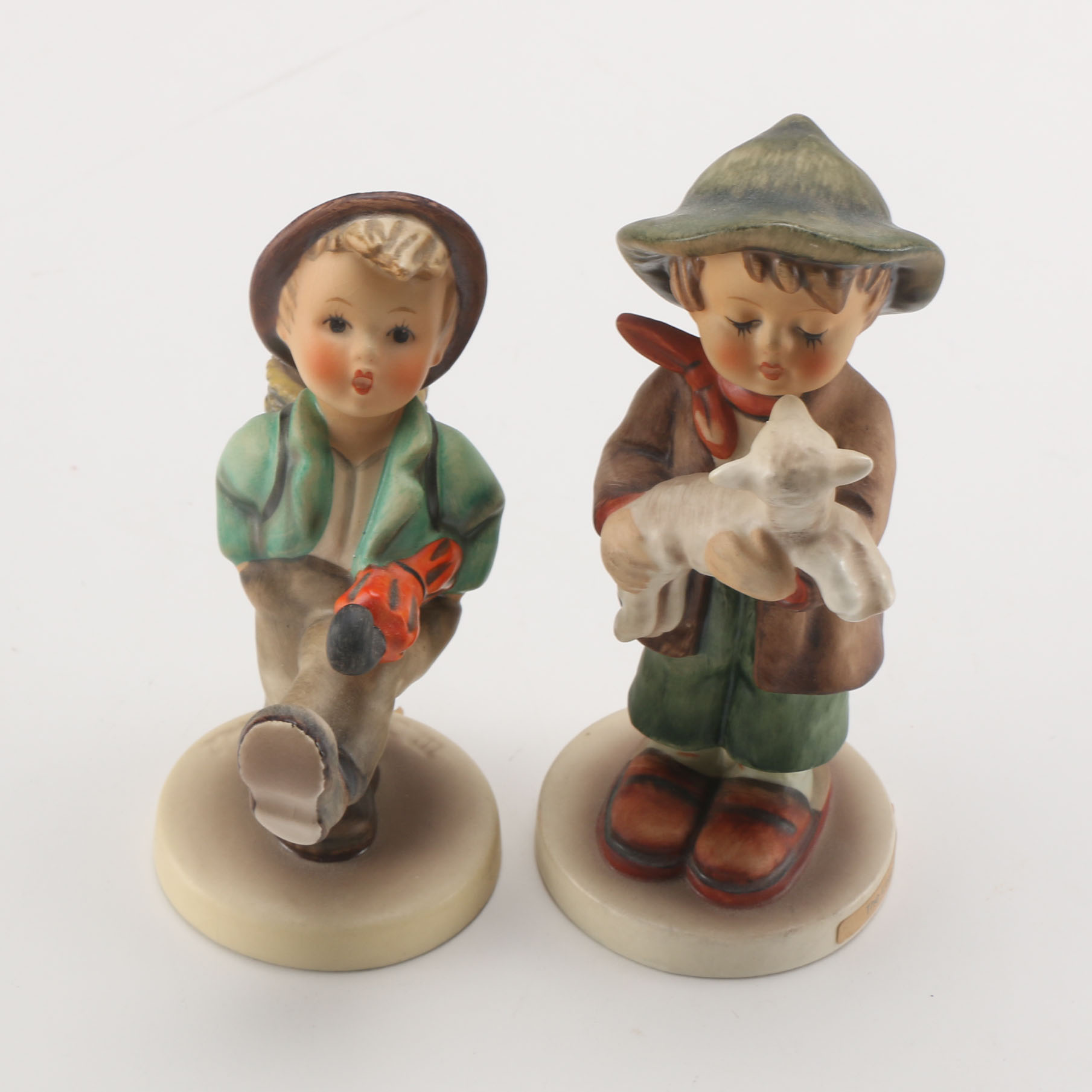 Goebel Hummels "Little Tooter", "Village Boy", "Globe Trotter", and "Lost Sheep"