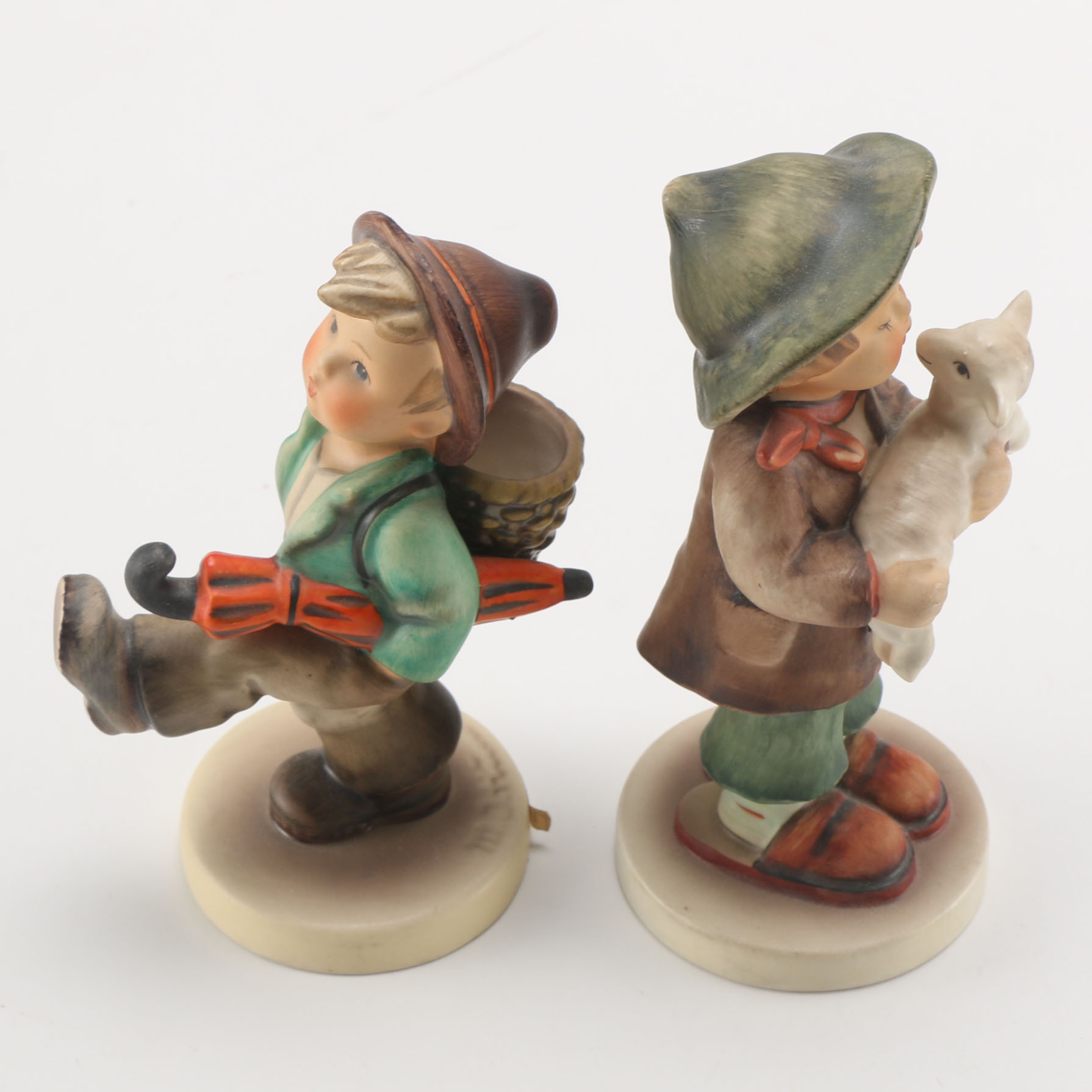 Goebel Hummels "Little Tooter", "Village Boy", "Globe Trotter", and "Lost Sheep"