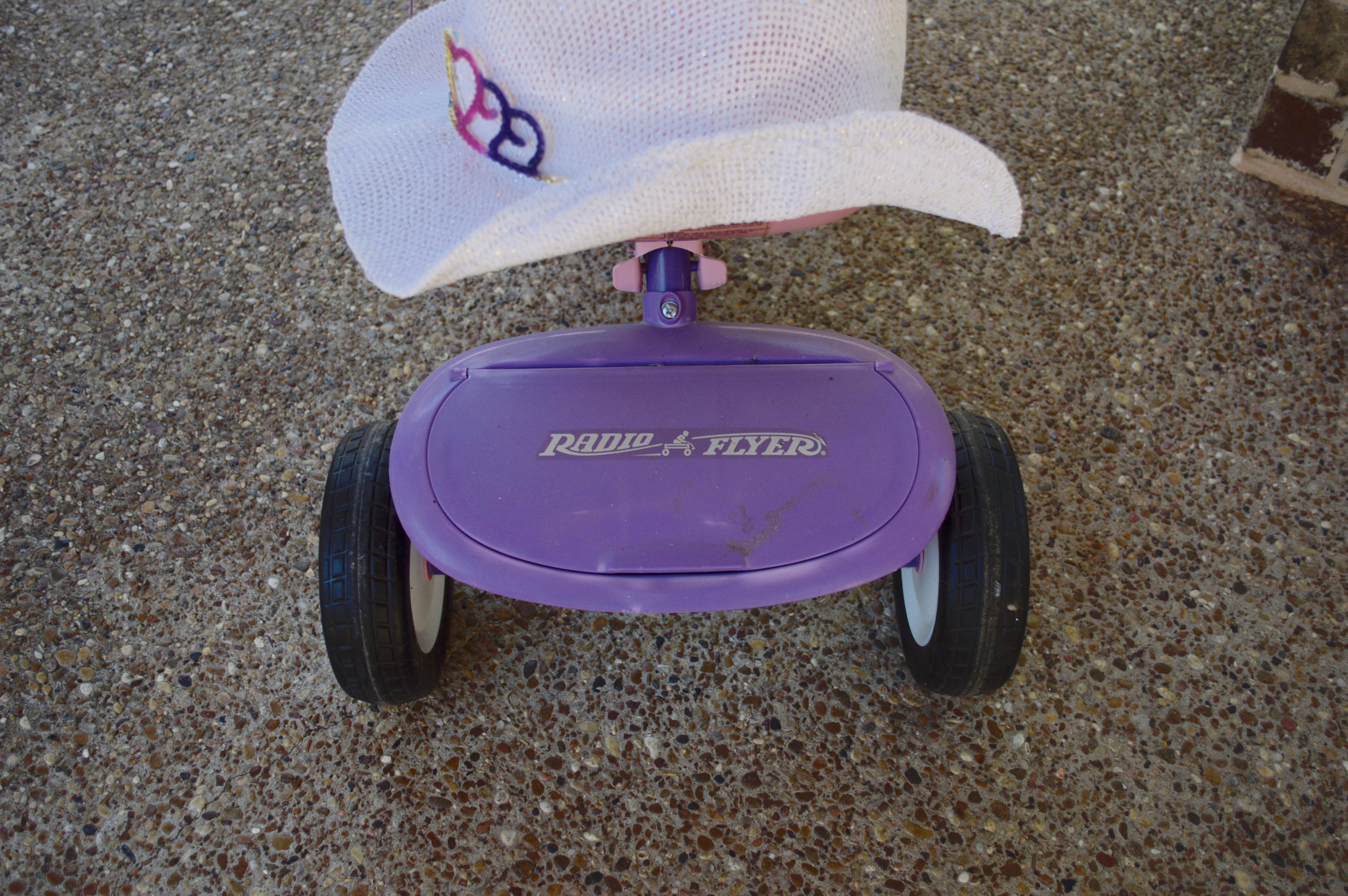 Pink and Purple Radio Flyer Tricycle and Cowgirl Hat
