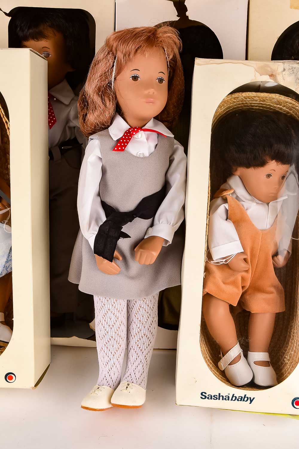 Collection of Eight "Sasha" Dolls, with Doll Trunk and Clothing