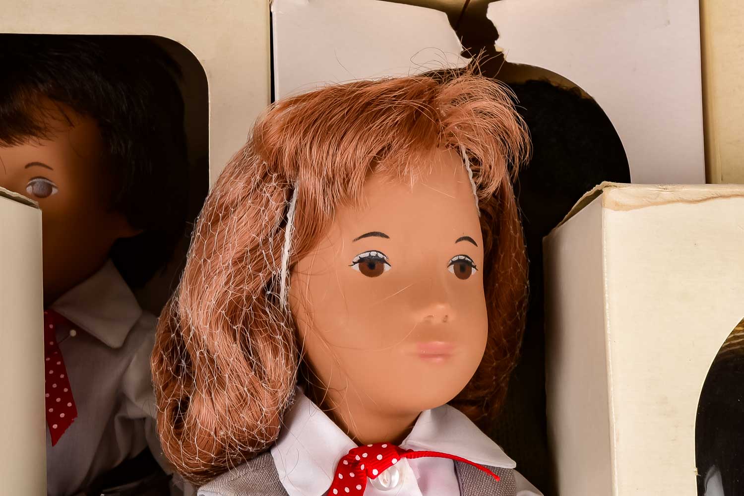 Collection of Eight "Sasha" Dolls, with Doll Trunk and Clothing