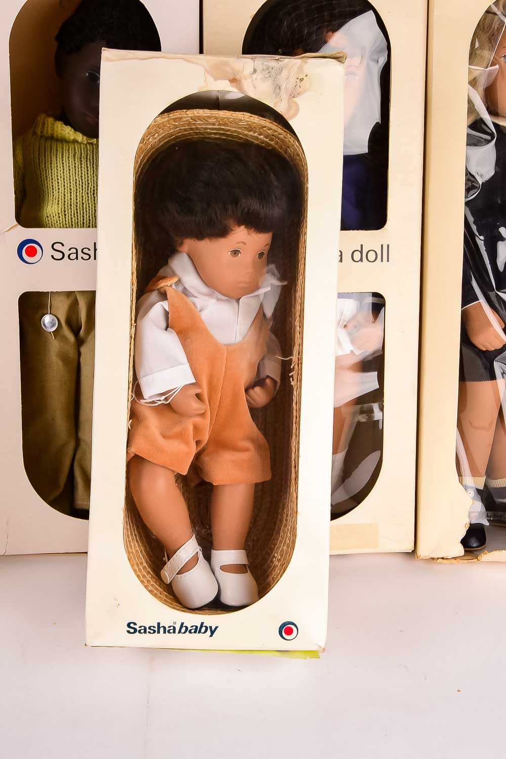 Collection of Eight "Sasha" Dolls, with Doll Trunk and Clothing