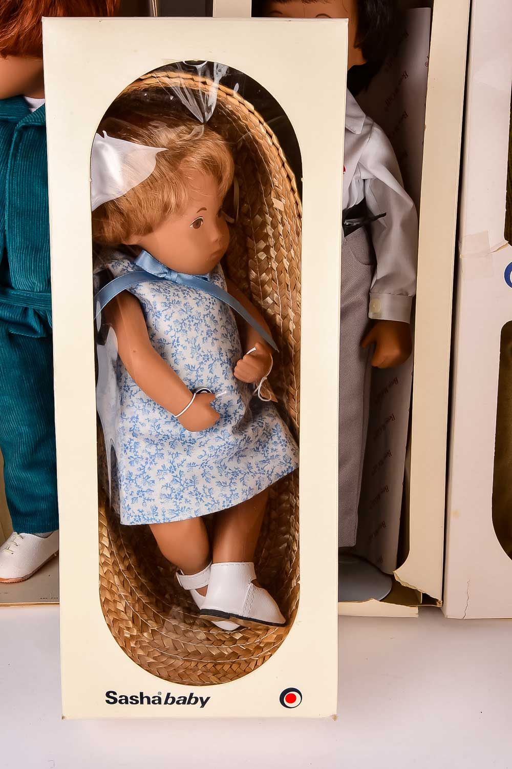 Collection of Eight "Sasha" Dolls, with Doll Trunk and Clothing