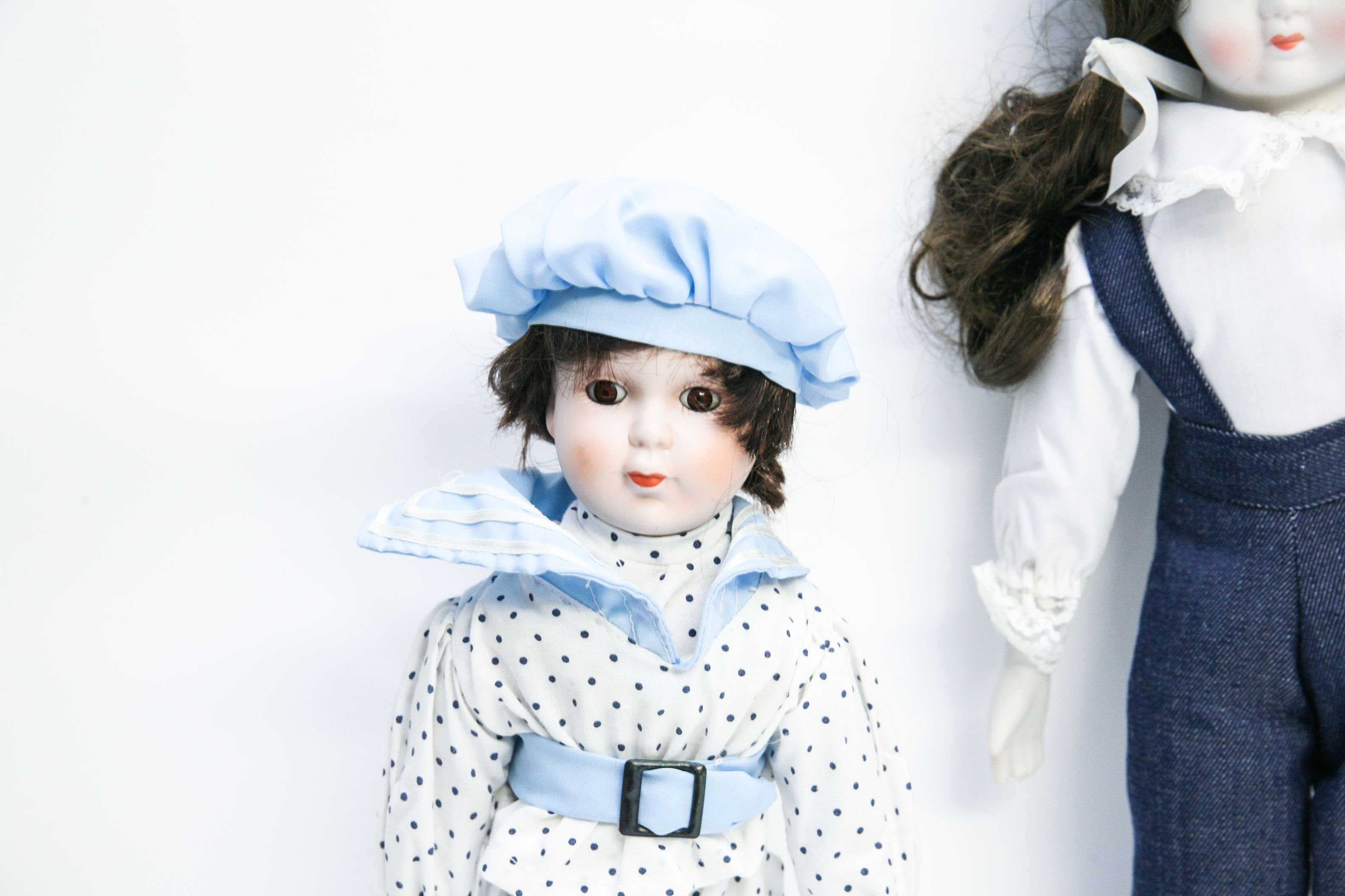 Two Porcelain Dolls in Menswear-Inspired Clothing