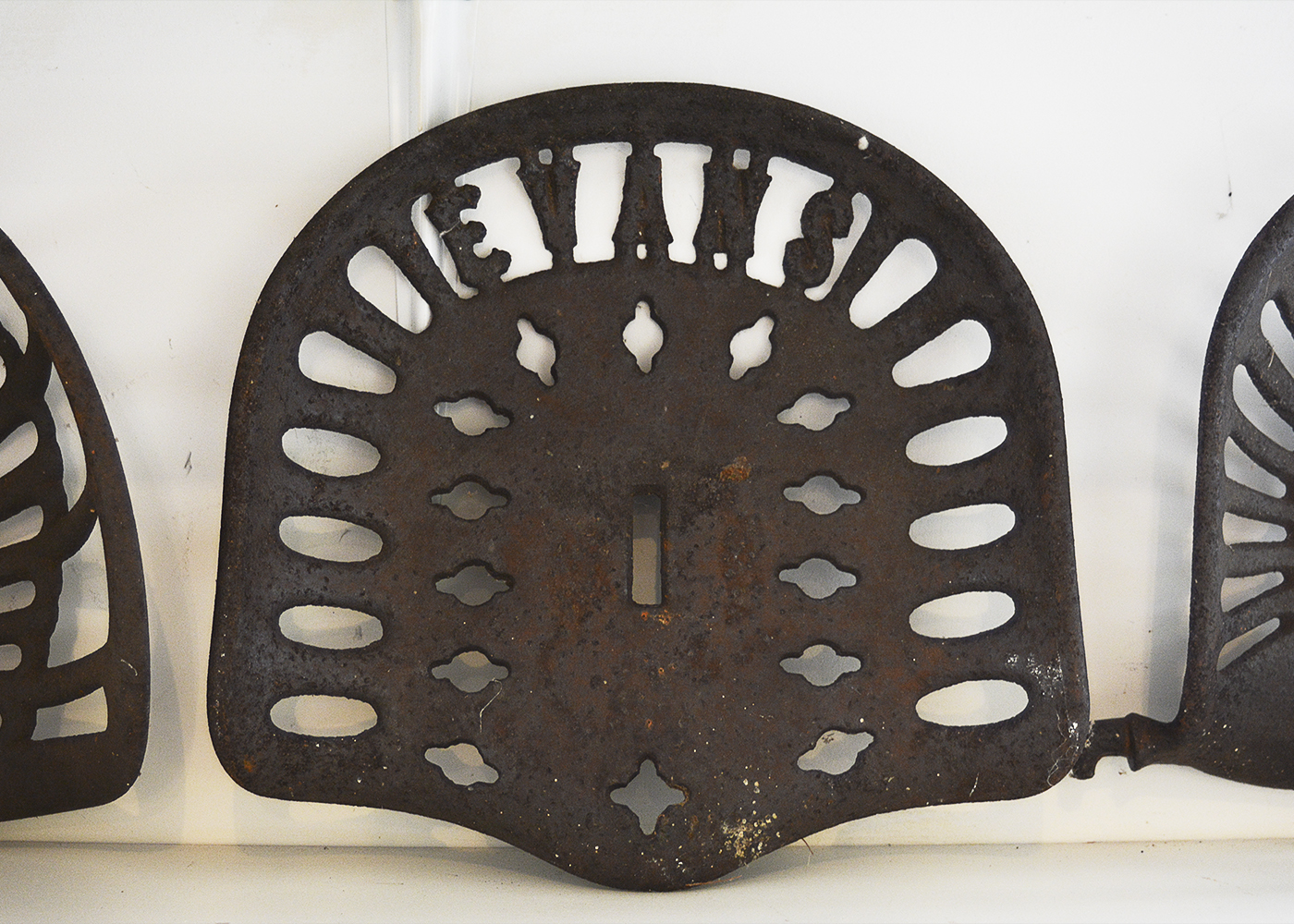 Five Vintage Cast Iron Tractor Seats
