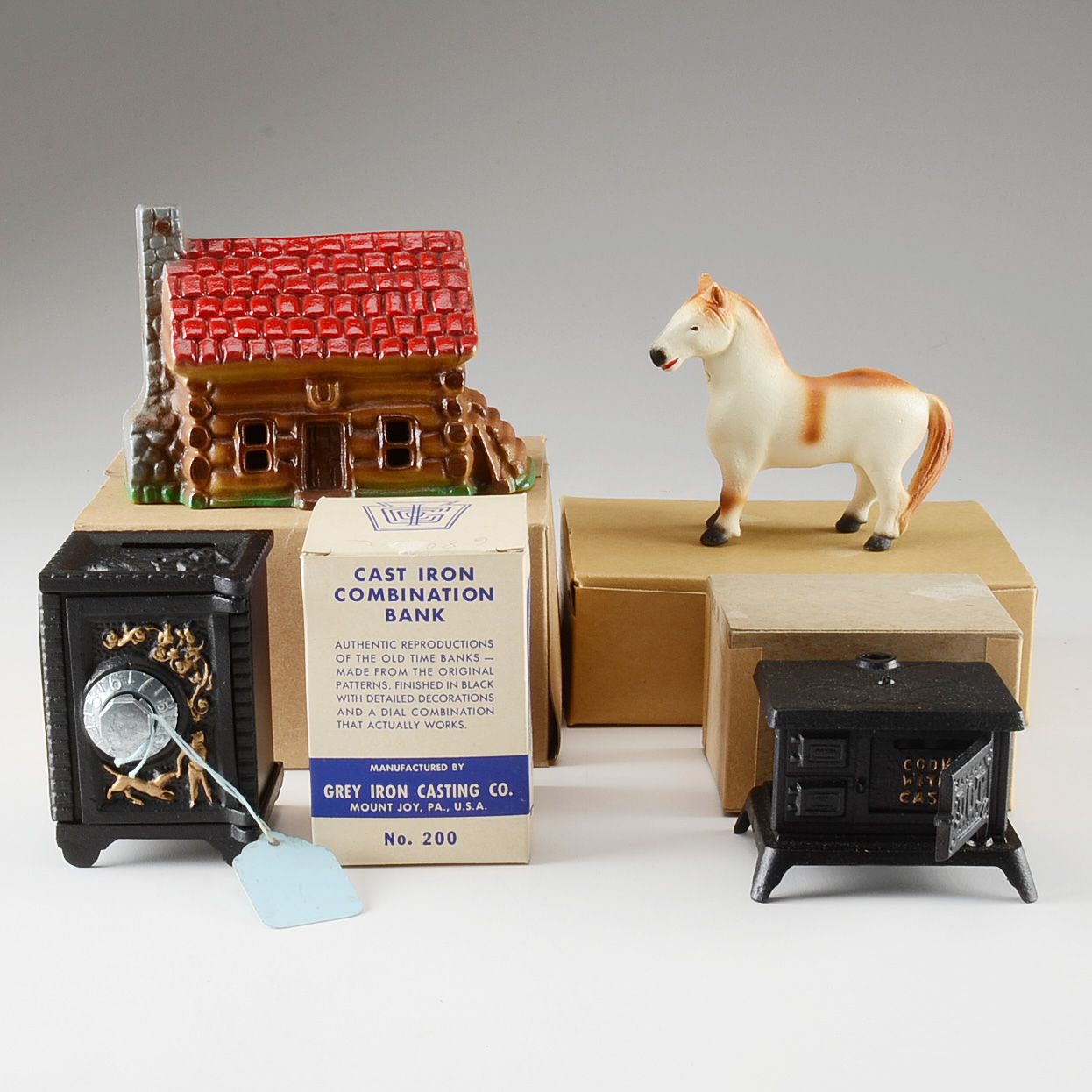 Collection of Four Cast Iron Penny Banks