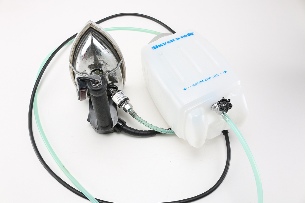 Pair of Clothes Irons and a Hanging Rack