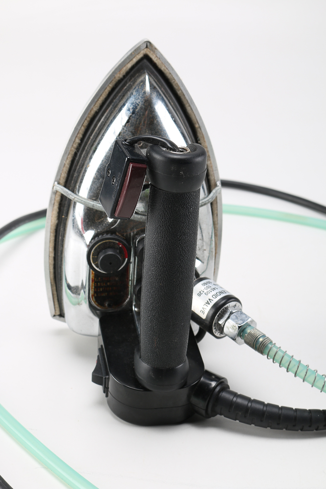 Pair of Clothes Irons and a Hanging Rack