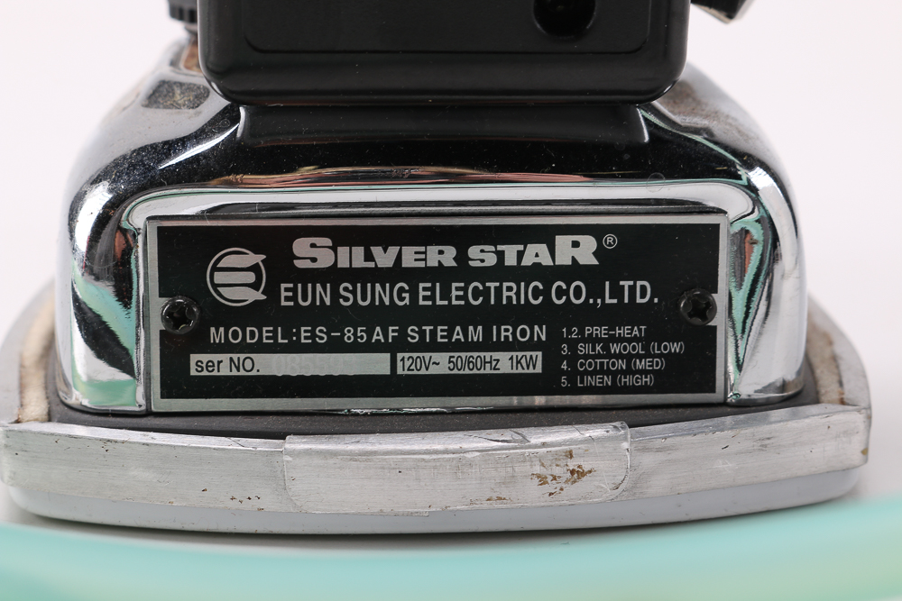 Pair of Clothes Irons and a Hanging Rack