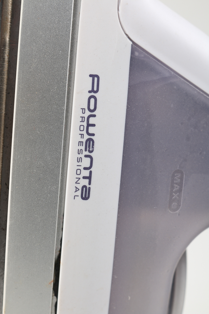 Pair of Clothes Irons and a Hanging Rack