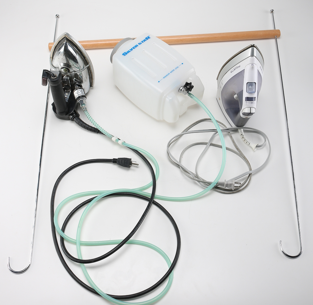 Pair of Clothes Irons and a Hanging Rack