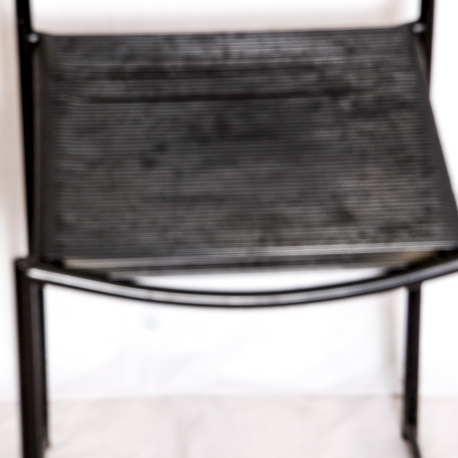 Two Black Metal Frame Chairs with Rubber Cord Seats