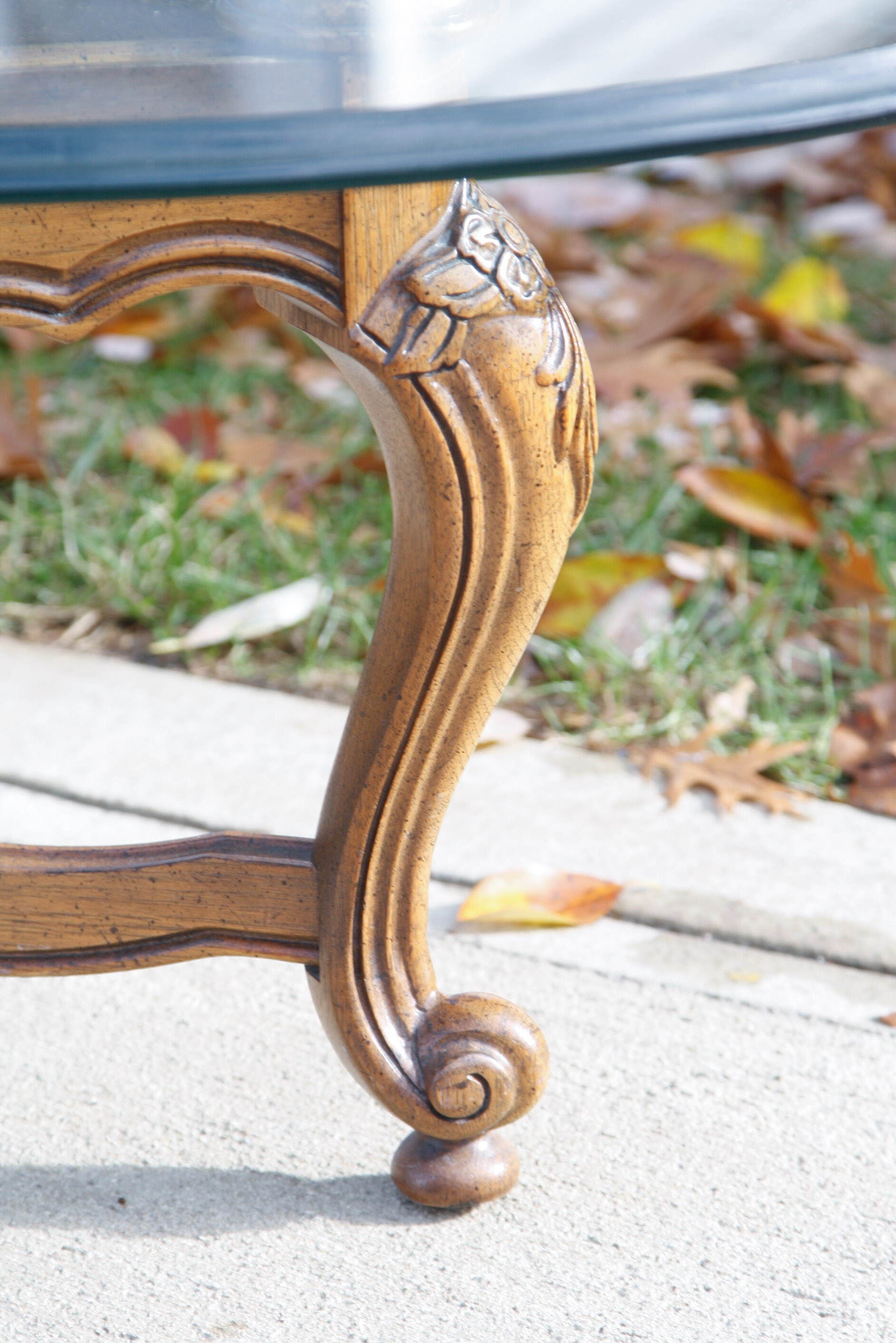 Oval Glass Top Coffee Table with Carved Wood Base