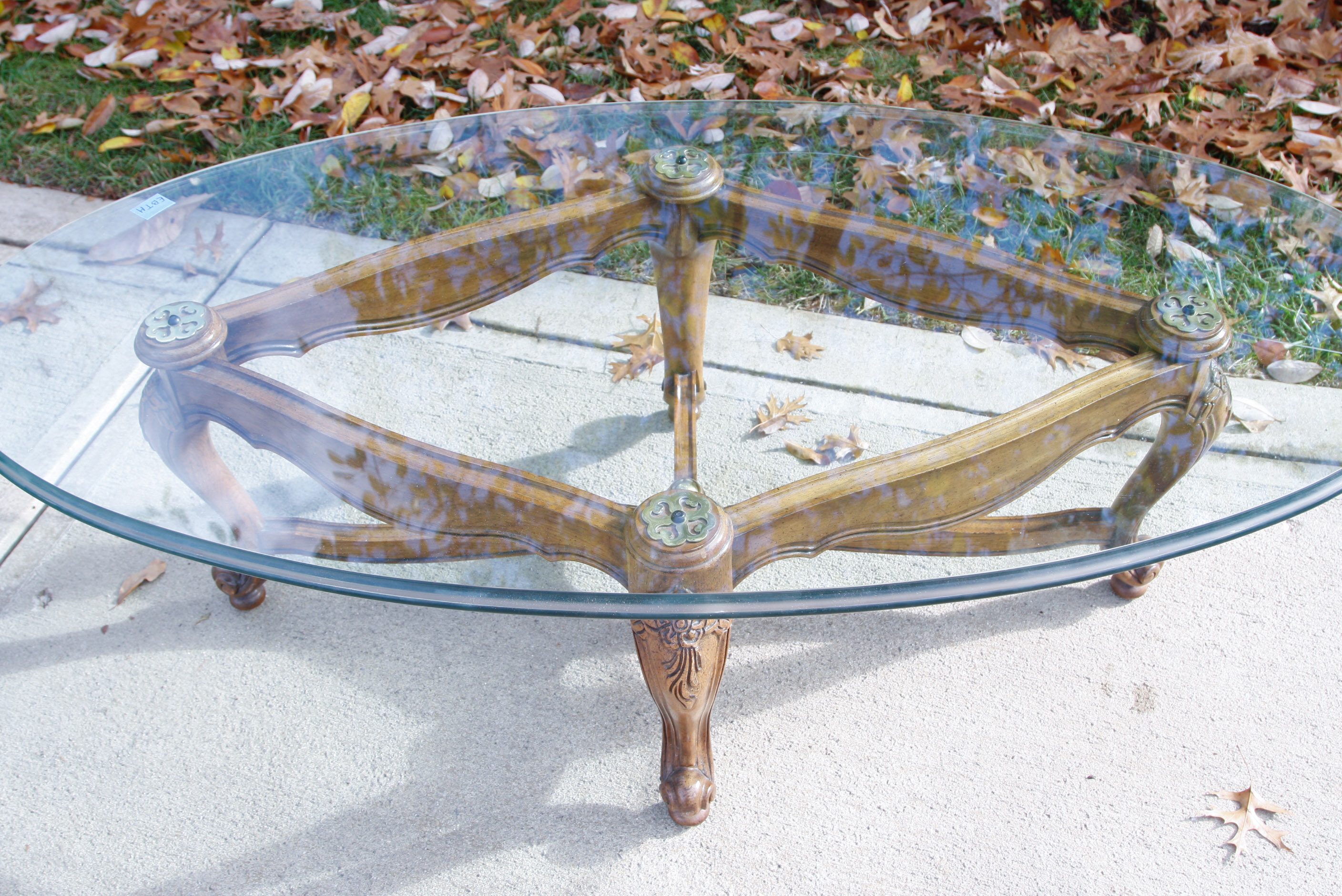 Oval Glass Top Coffee Table with Carved Wood Base
