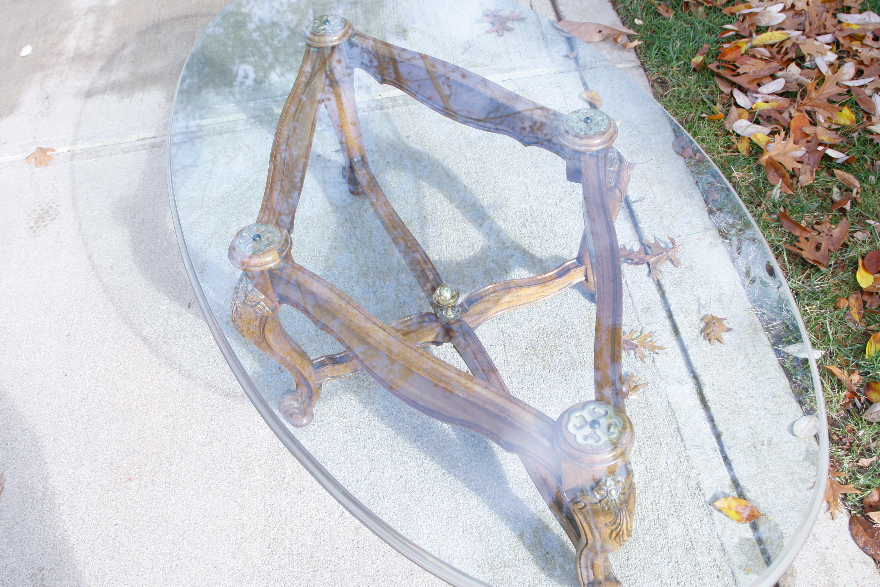 Oval Glass Top Coffee Table with Carved Wood Base