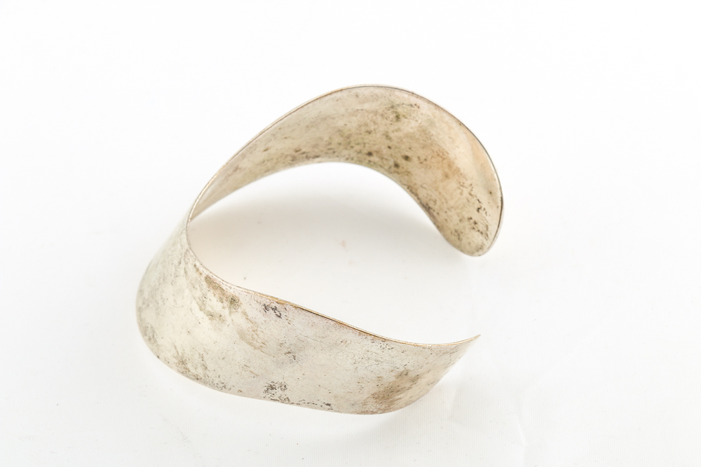 Collection of Metal Bracelets and a Pin