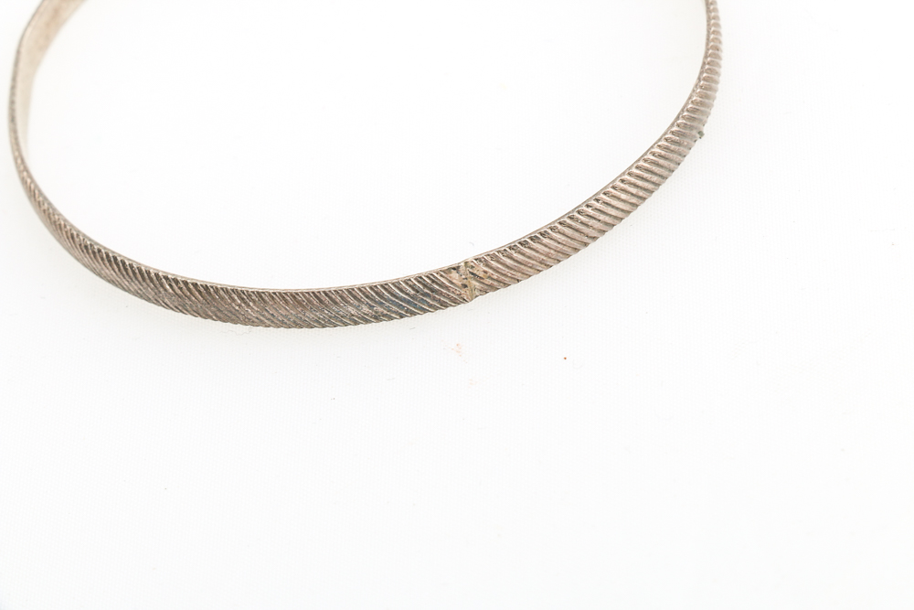 Collection of Metal Bracelets and a Pin