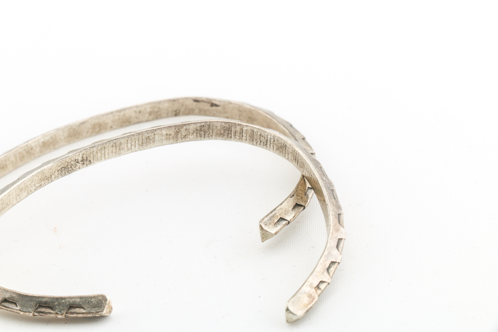 Collection of Metal Bracelets and a Pin