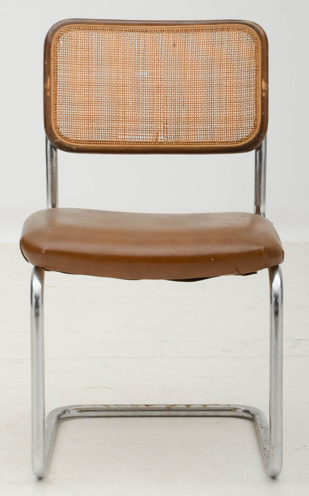 Three Cantilevered Side Chairs with Woven Cane Backs