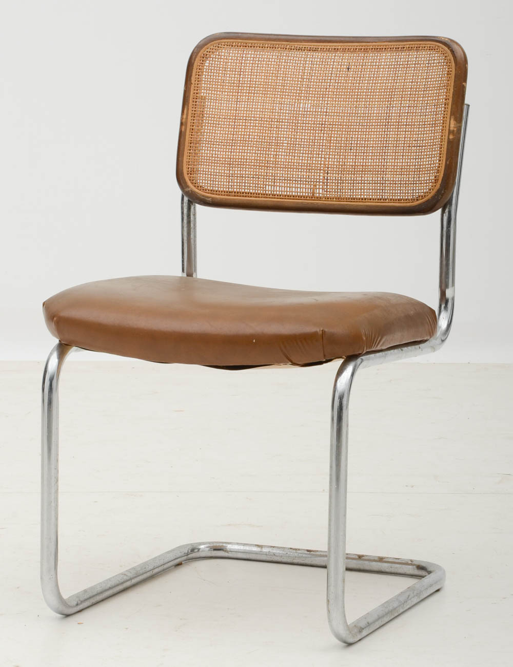 Three Cantilevered Side Chairs with Woven Cane Backs