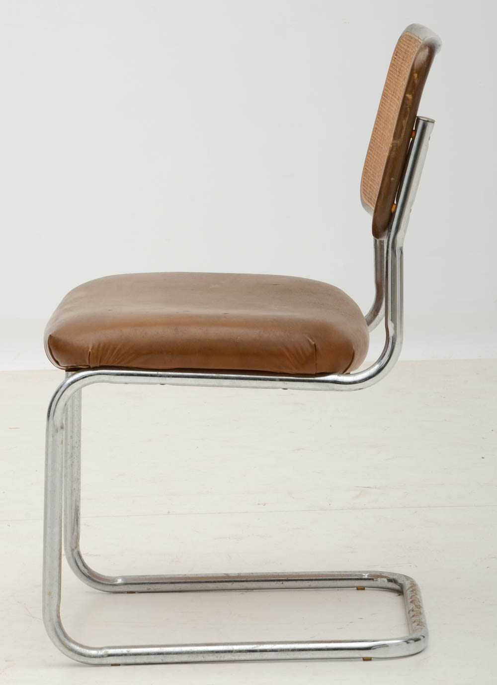 Three Cantilevered Side Chairs with Woven Cane Backs