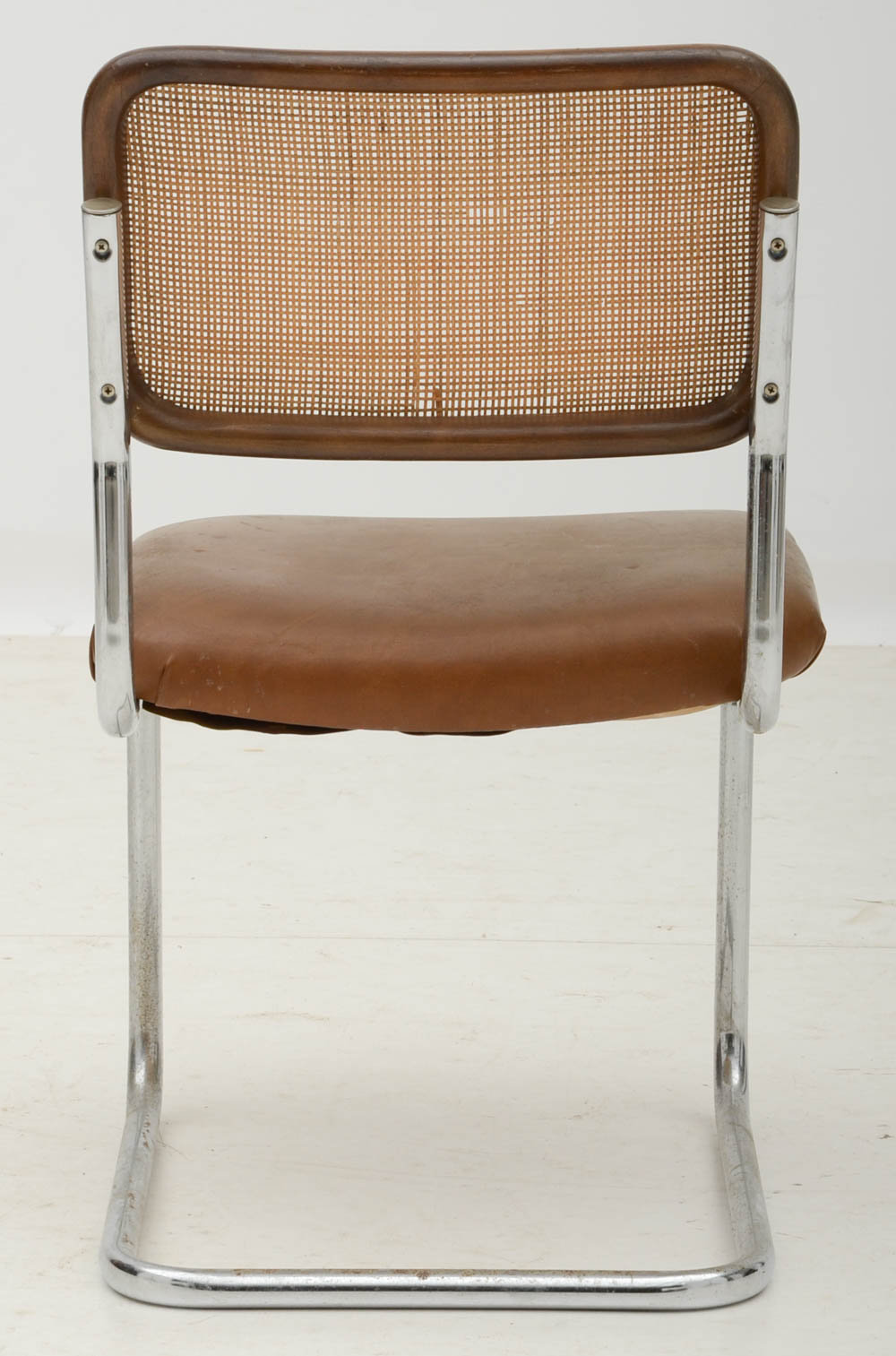 Three Cantilevered Side Chairs with Woven Cane Backs
